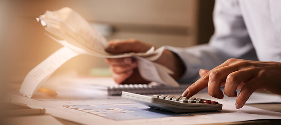 Accountant working with receipts and a calculator.