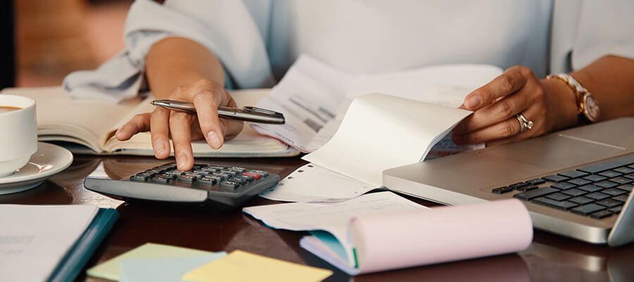 Close up of a person using a calculator.