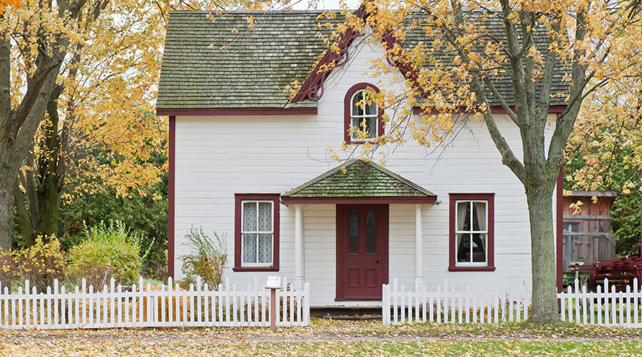 Suburban house surrounded by autumn leaves.