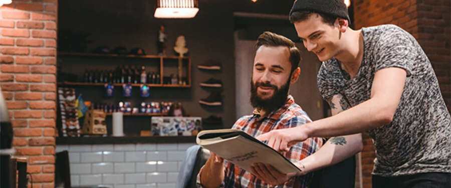 Two men inside a barbershop.