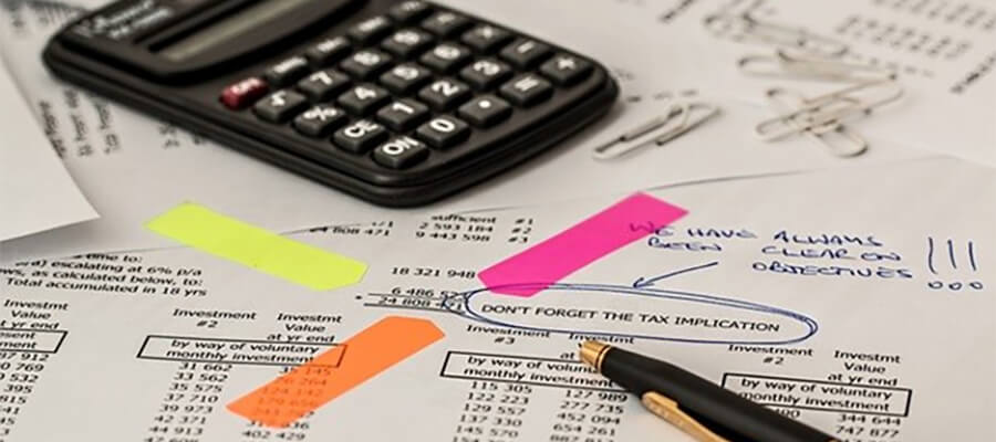 Bookkeeper's desk with calculator and accounts.