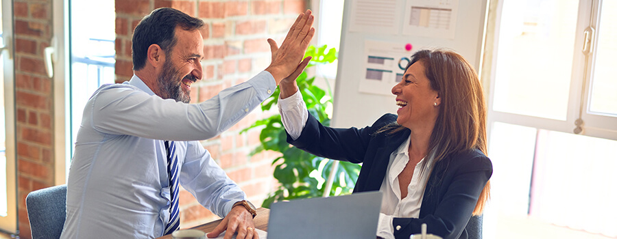 Office workers high five.