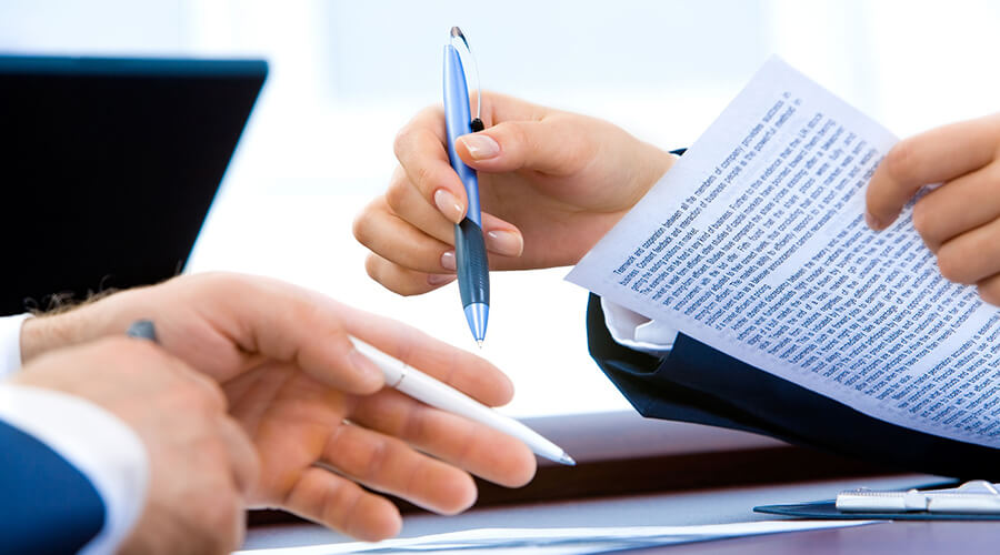 Close up of two people reviewing a document.