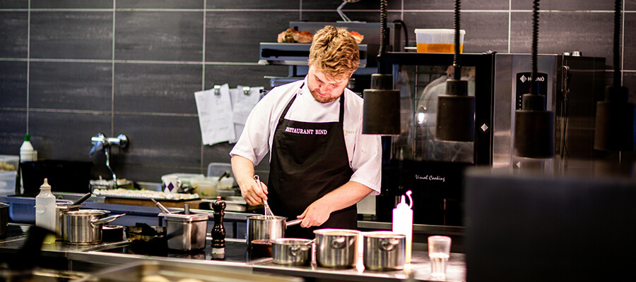 Chef preparing food in a kitchen.