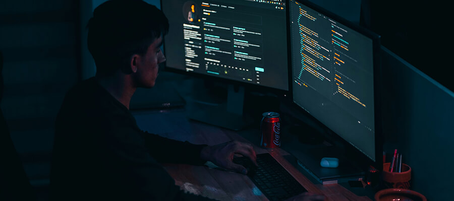 Coder coding in a dark room.
