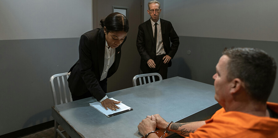 Criminal lawyer visiting a prisoner.