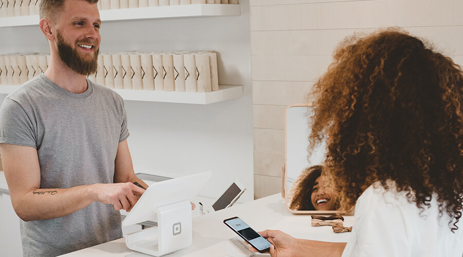 Customer making a contactless payment with phone.