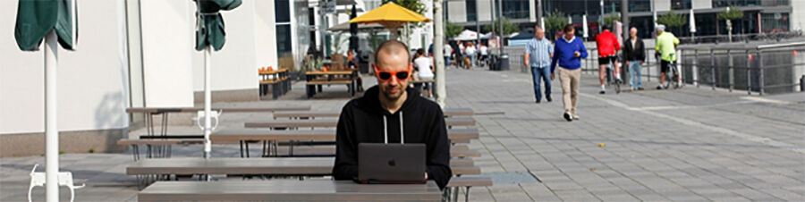 Man using a laptop in a foreign location.