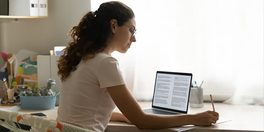 An editor sitting at a desk working on a computer