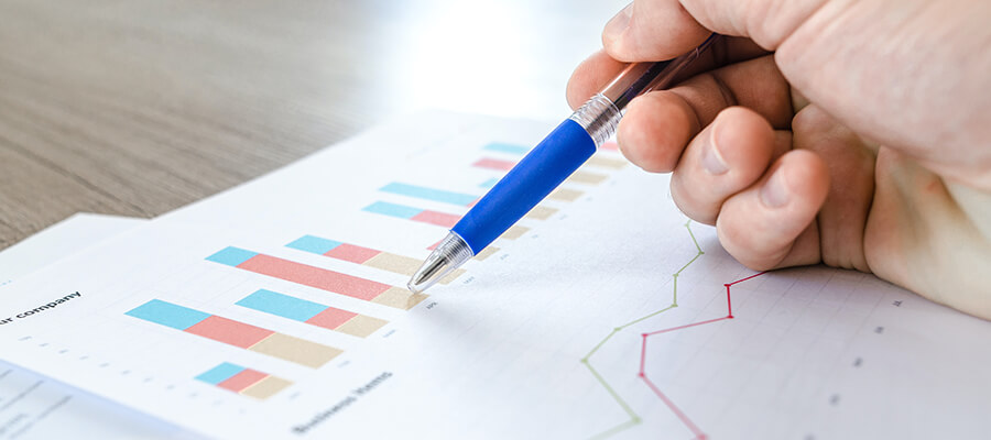 Using a pen to point to bar charts.