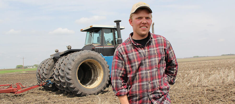 Farmer and his tractor on a ploughed field.