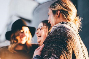 A group of female friends laughing about something.