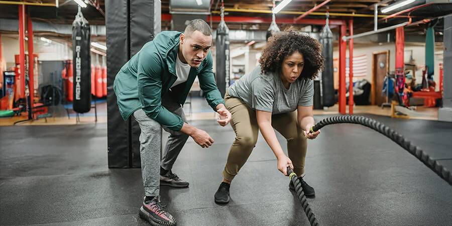 Fitness coach woring with a client.