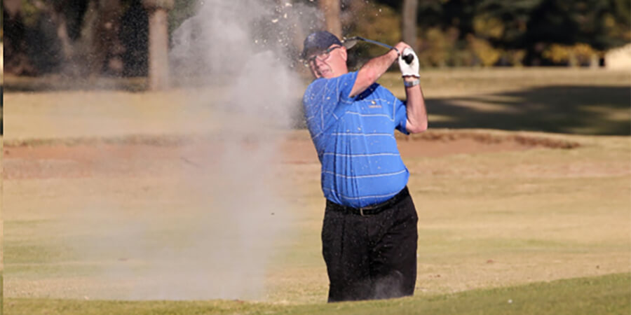 Older person playing golf.