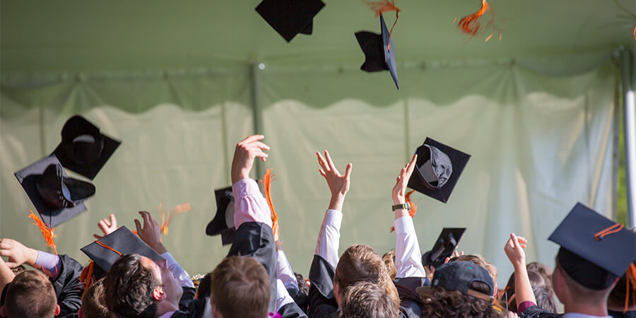 Throwing hats in the air at graduation.