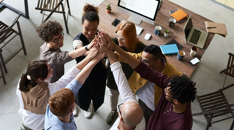 Group of people giving a high-five.