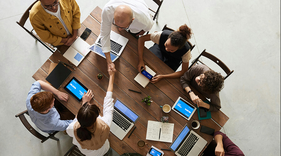 Handshake over a conference table.