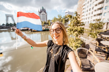 A person holding a Dutch flag.