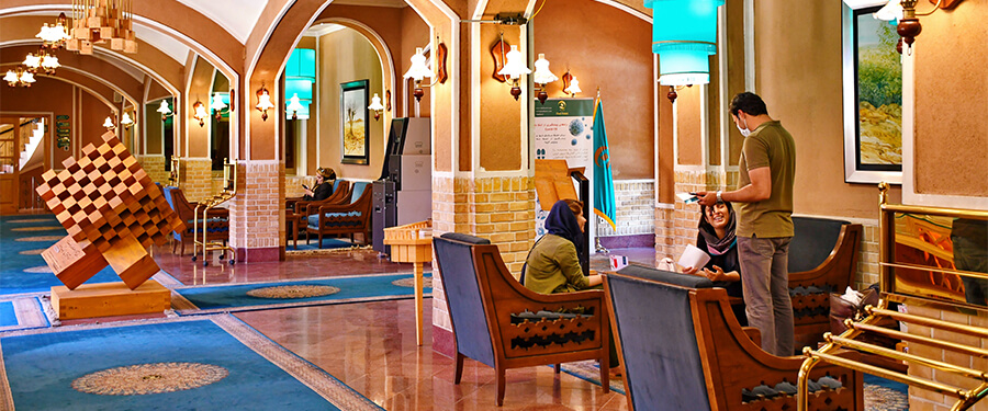 Lobby of a 5 star hotel with member of staff helping guests.