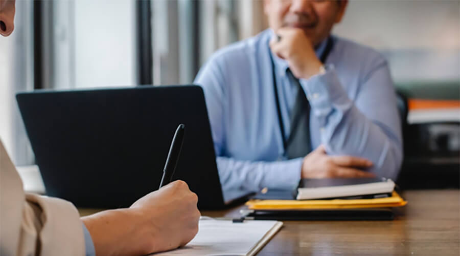 Interviewer taking notes during and interview.