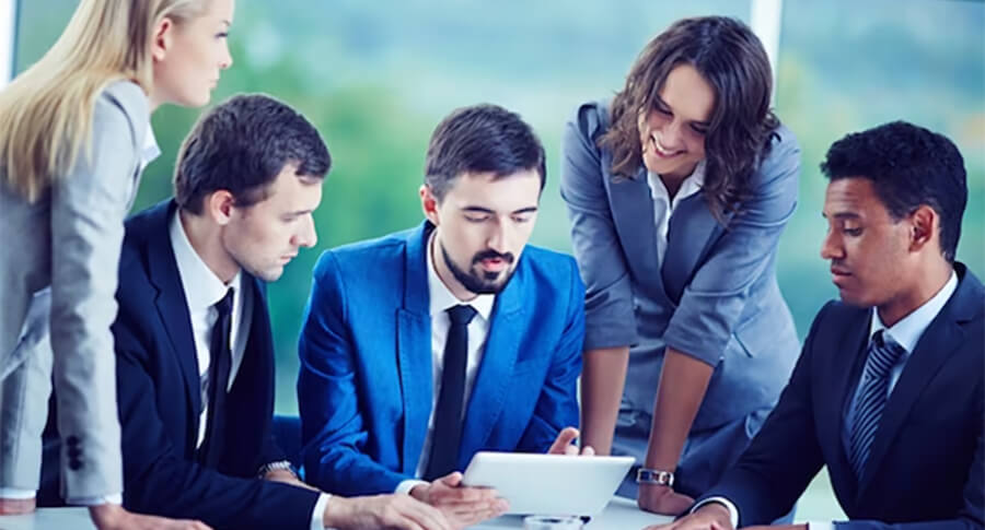 Group of young professionals looking at a tablet.