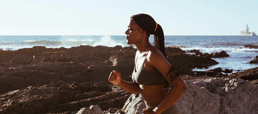 Woman jogging on the coast.