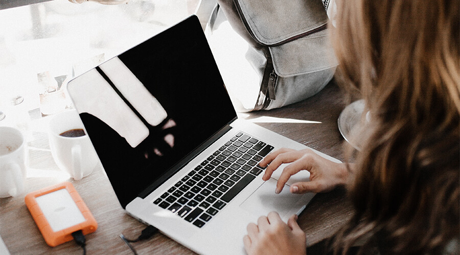 Woman working on a laptop.