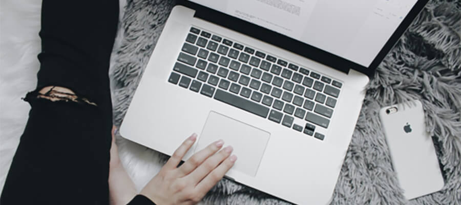 Laptop on a shaggy grey rug.