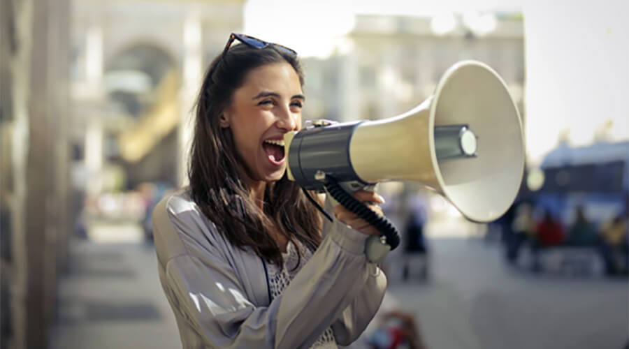 Woman using a megaphone or loudhailer.