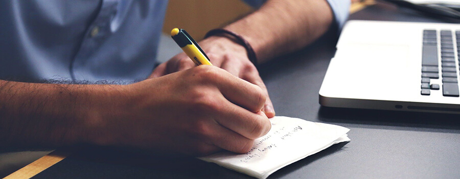 Man making notes in a notebook.