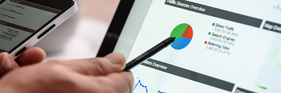 Pen pointing to a pie chart showing website traffic.