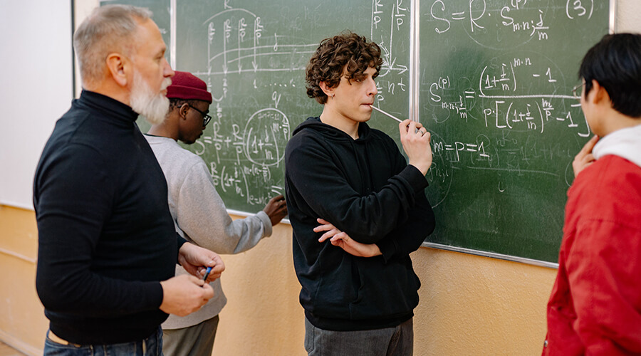 Teacher and group of young people thinking about math problems.