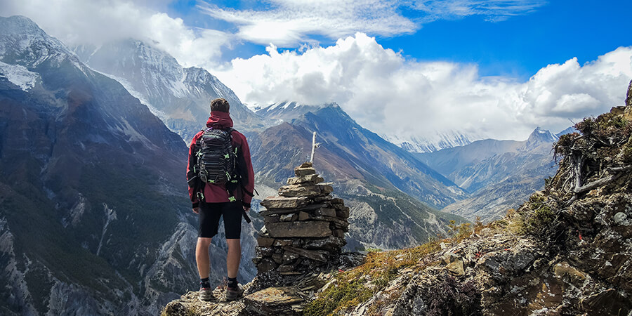 Hiker standing on top of a mountain.