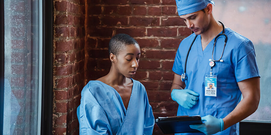 Nurse and patient looking at test results.