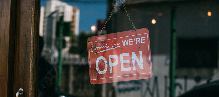 Open sign on American shop door.