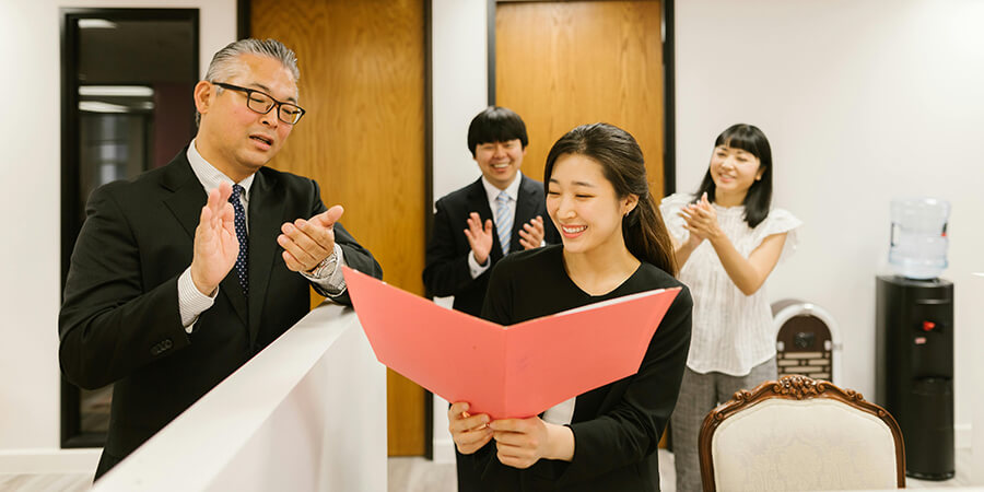 Woman worker being awarded a certificate.