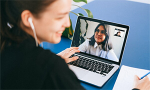 Woman making a video call on a laptop.