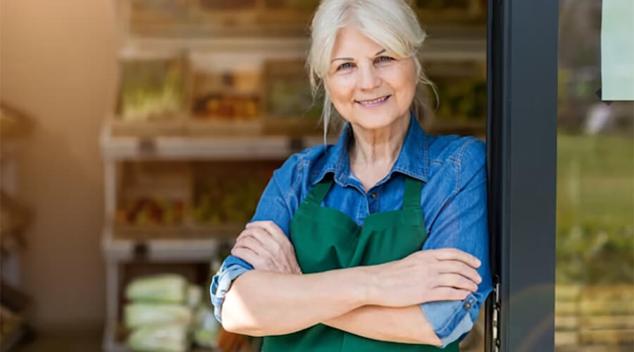 Retired person wearing a green apron.