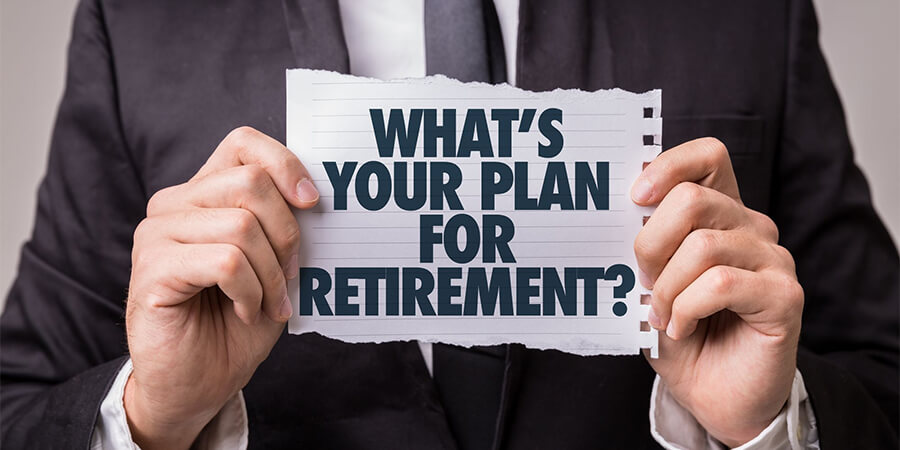 Perspn holding a piece of paper with 'What's your plan for retirement' printed on it.