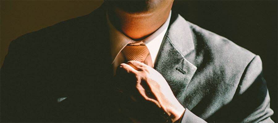 Man straightening his tie.