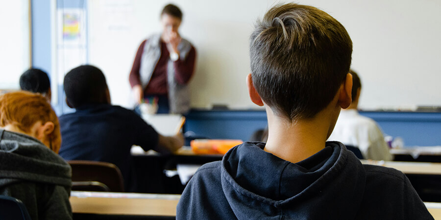 Back of students heads in a classroom.