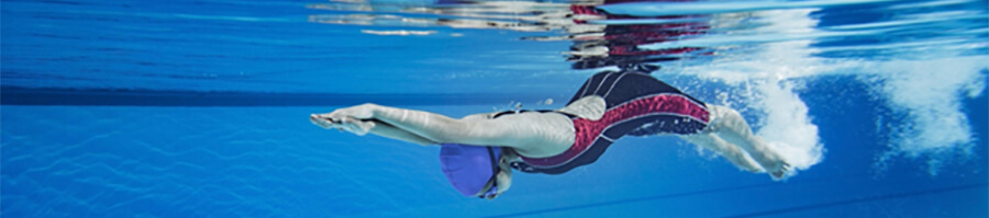 Swimmer underwater in a pool.