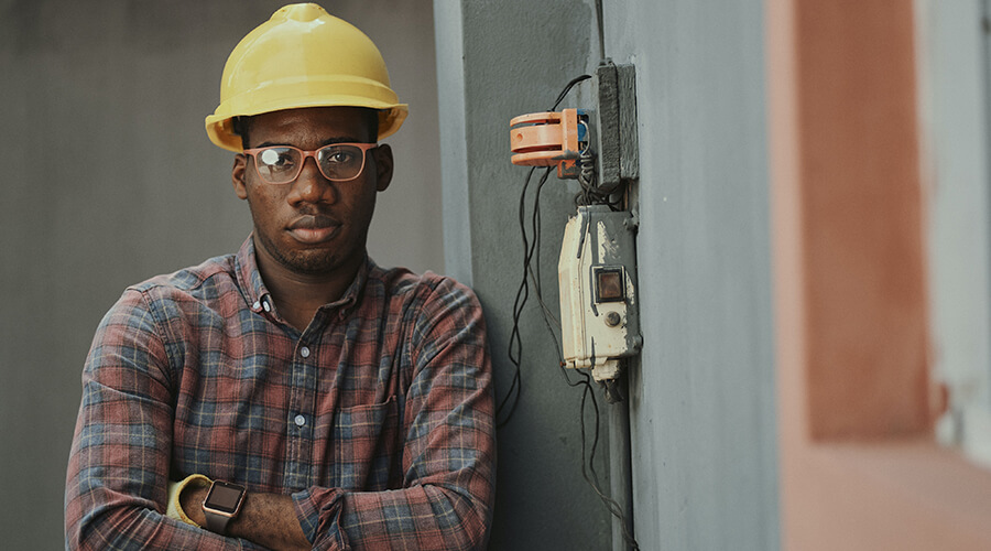 Tradesperson wearing a yellow hard hat.