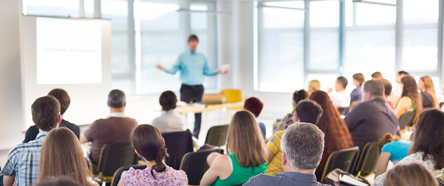 Trainer leading a training session to a large group.