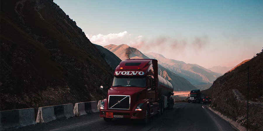 Large Volvo truck driving through the mountians.