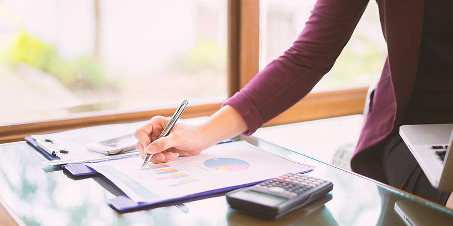 Writing on a sheet of paper with charts.